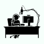 A person sitting at a desk with a microphone and computer, recording a podcast.